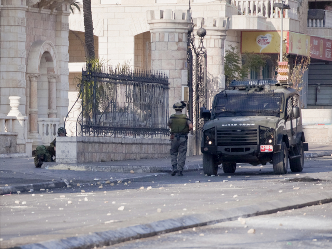 Rehab Nazzal, The last photograph my lens captured showing the Israeli sniper who shot me, on the ground of Jacir’s Hotel entrance. Dec 11, 2015.